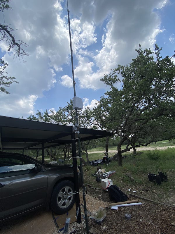 An antenna resting against an outdoor carport