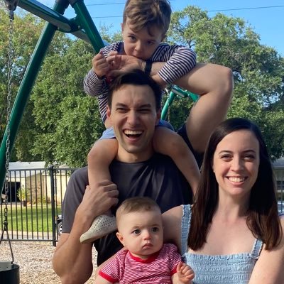 Picture of John and his wife holding 2 toddlers